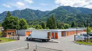 Cowichan Valley Self Storage facility in Duncan BC with a moving truck being unloaded against a backdrop of scenic mountains.