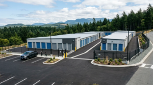 Aerial view of a modern Nanaimo self-storage facility with secure blue-door units and mountain backdrop